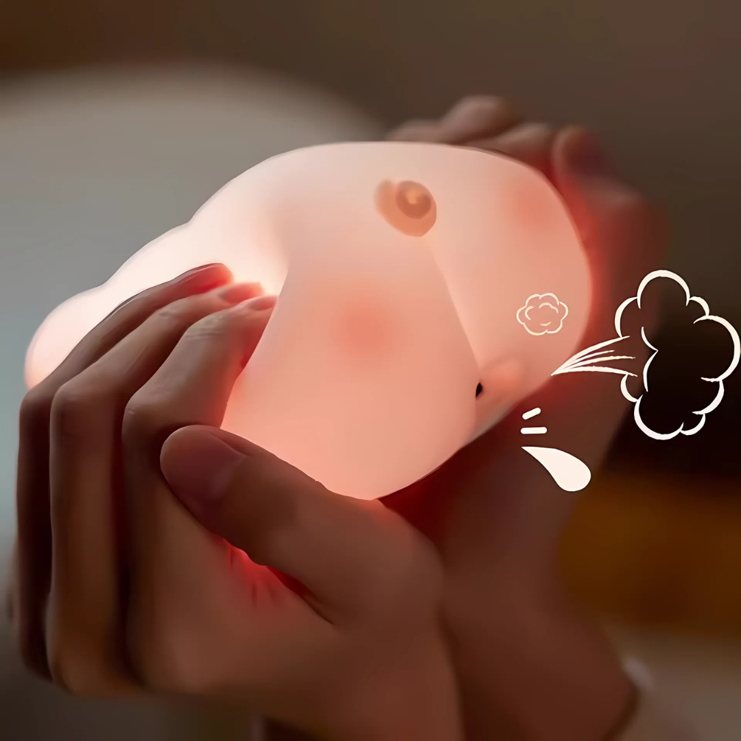 Person Squishing a Glowing Pink Pig Light - Tinyminymo