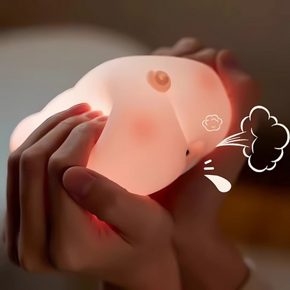 Person Squishing a Glowing Pink Pig Light - Tinyminymo