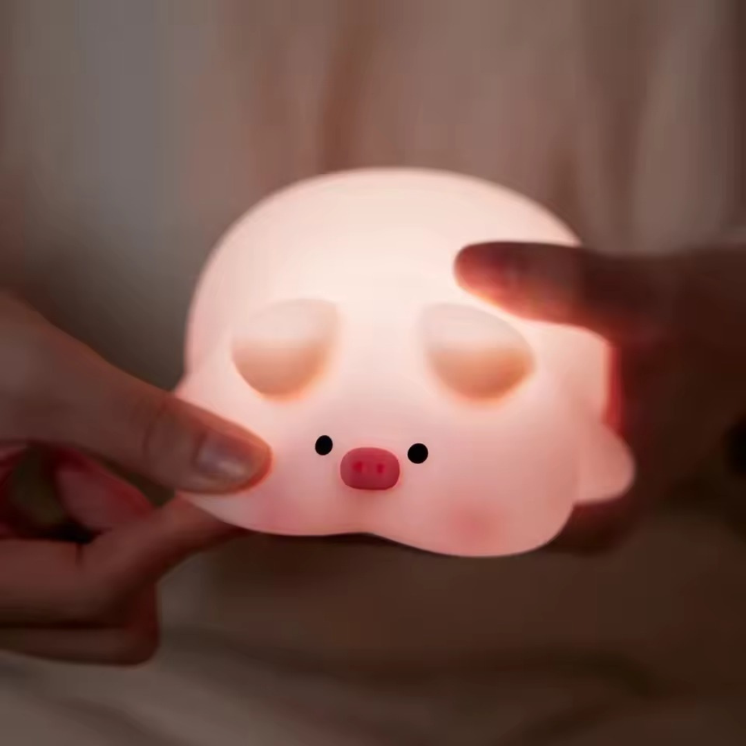 Cute Pig Night Light Held by a Hand Against a Soft Background - Tinyminymo