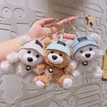 Load image into Gallery viewer, Three Cute Teddy Plush Keychain with different colored hats held by a hand against a neutral background - Tinyminymo
