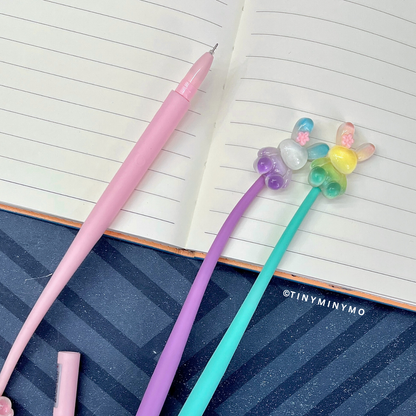 Four Colorful Dancing Bunny Gel Pens Placed on an Opened Lined Notebook Page – Tinyminymo