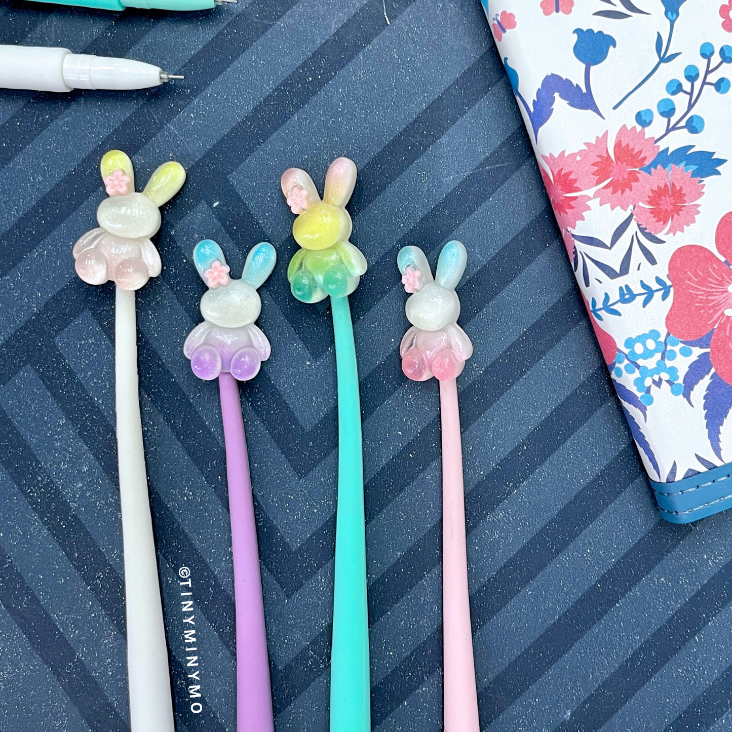 Four Colorful Dancing Bunny Gel Pens Placed on a Striped Background – Tinyminymo