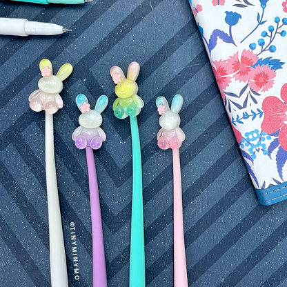 Four Colorful Dancing Bunny Gel Pens Placed on a Striped Background – Tinyminymo
