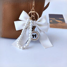 Load image into Gallery viewer, White Bow Mobile Charm Hanging on a Bag - Tinyminymo

