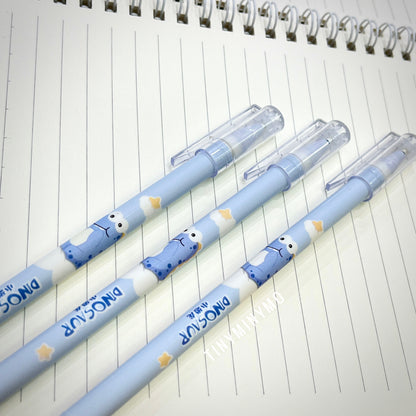 Three Blue Pens with Dinosaur Characters on a lined notebook page - Tinyminymo