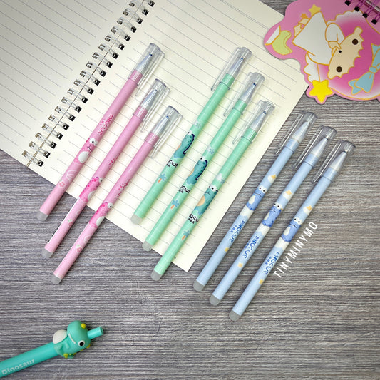 Set of Colorful Erasable Dinosaur Gel Pens on a Wooden Surface with a Notebook - Tinyminymo