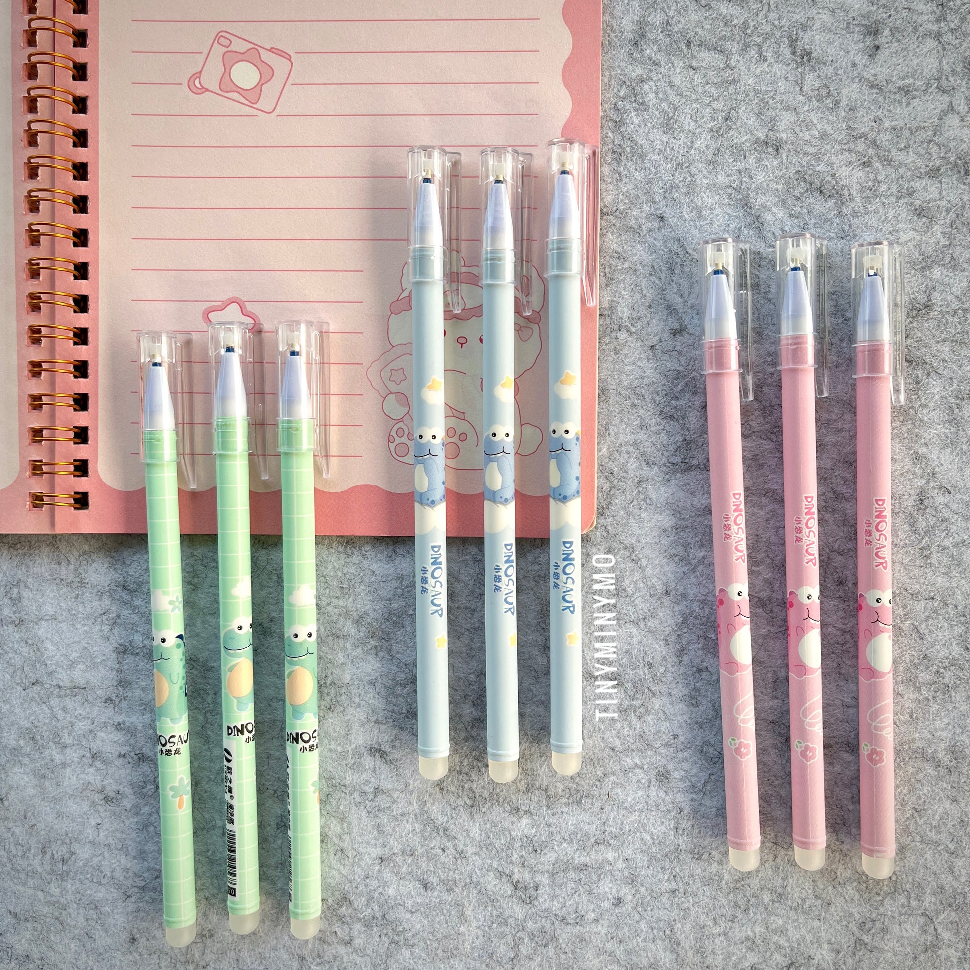Set of Dinosaur-Themed Pens in 3 Colors on a Textured Surface - Tinyminymo