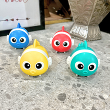 Load image into Gallery viewer, Four Colorful Fish 2 in 1 Sharpener and Eraser on a Textured Surface with a Blurred Background - Tinyminymo
