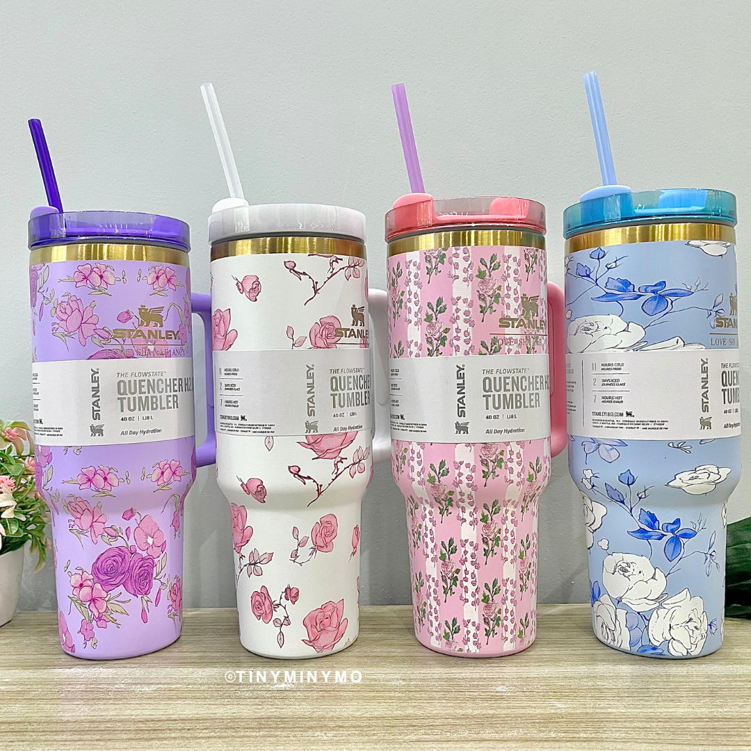 Four Colourful Floral Stanley Cups with Straws on a Wooden Surface - Tinyminymo