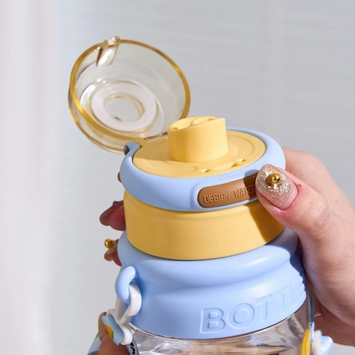 The Bottle is Shown with its Flip Top Lid Open - Tinyminymo