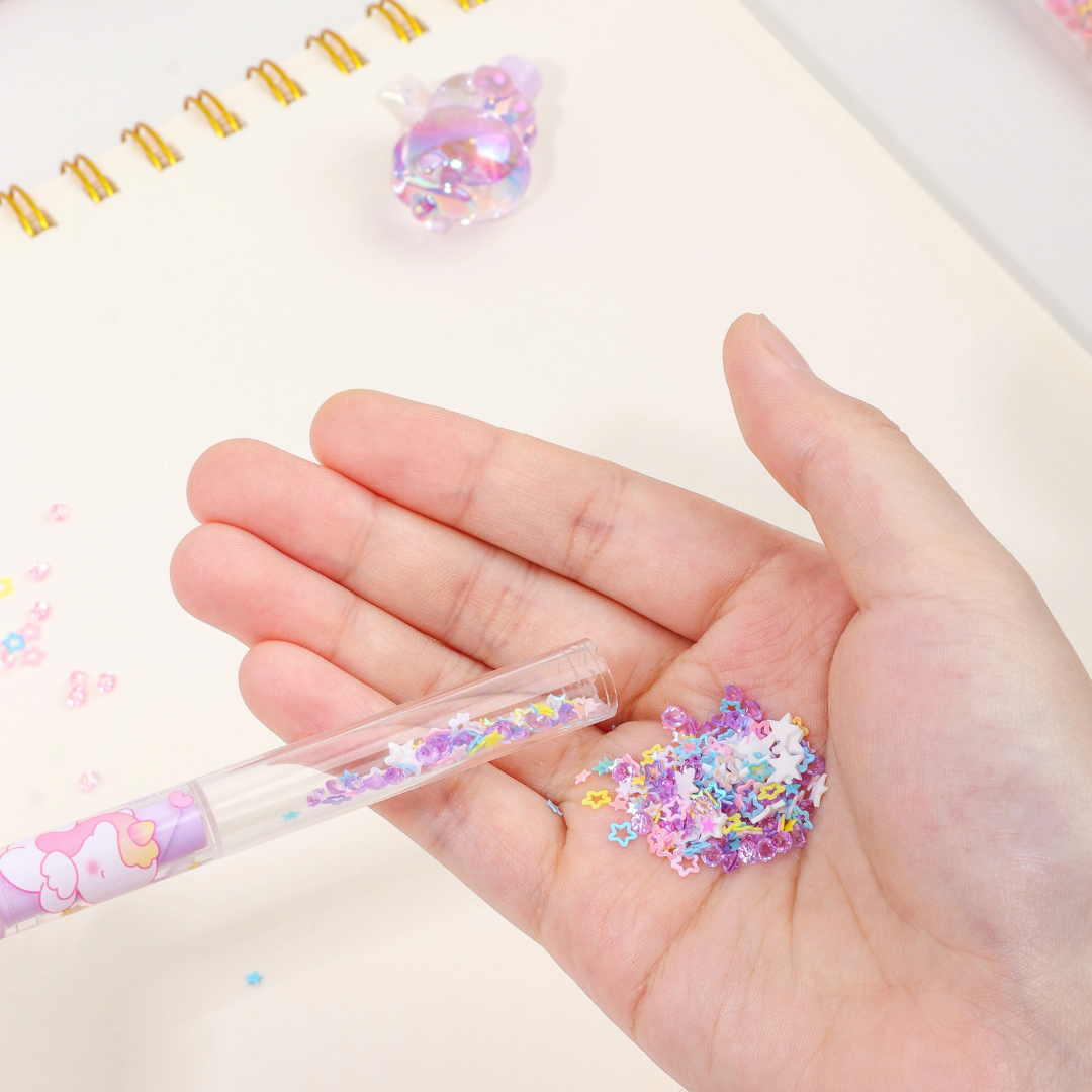 Hand Taking out the Beautiful Glitter Confetti from a  Purple Glitter Unicorn Pen - Tinyminymo