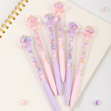 Load image into Gallery viewer, Both Variants of Glitter Unicorn Pen with Glittery Accents on a Notebook - Tinyminymo
