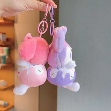 Load image into Gallery viewer, Side angle of Two fluffy keychains, One Pink and One Purple, with a Donut Design - Tinyminymo
