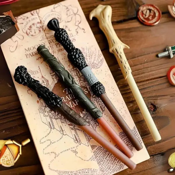 Four Harry Potter Wand Pen Designs on a Wooden Surface - Tinyminymo
