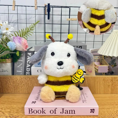 Honey Bee Cosplay Puppy Soft Toy Placed on a Book with Decorative Items and Books in the Background - Tinyminymo