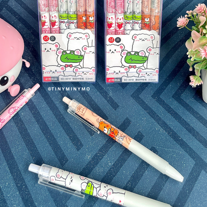 Kawaii Animal Gel Pens and Two Sets of Kawaii Animal Gel Pens on a Blue Textured Surface with Flowers - Tinyminymo