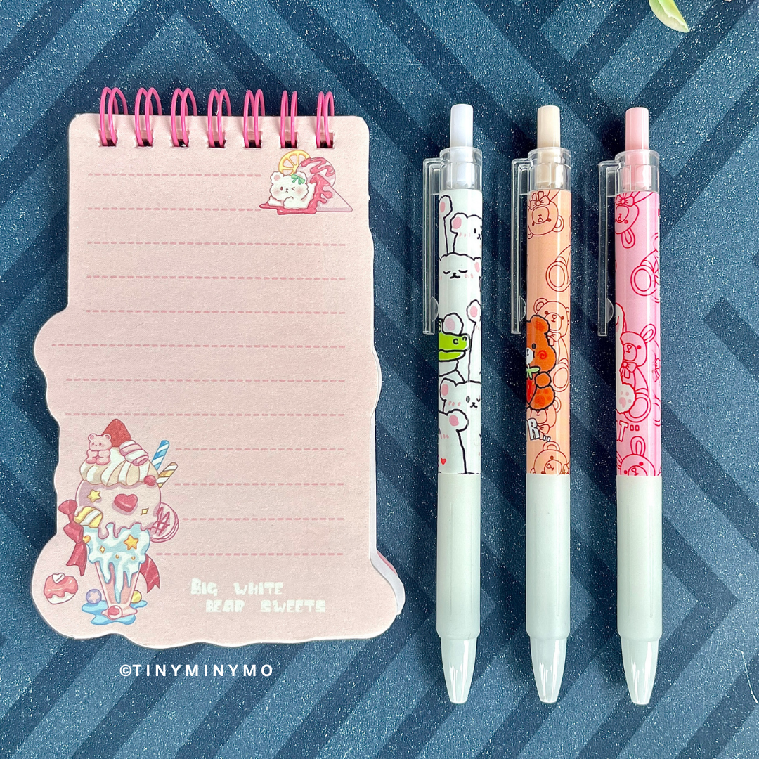 Pink Spiral Notepad and Three Kawaii Animal Gel Pens on a Blue Striped Background - Tinyminymo