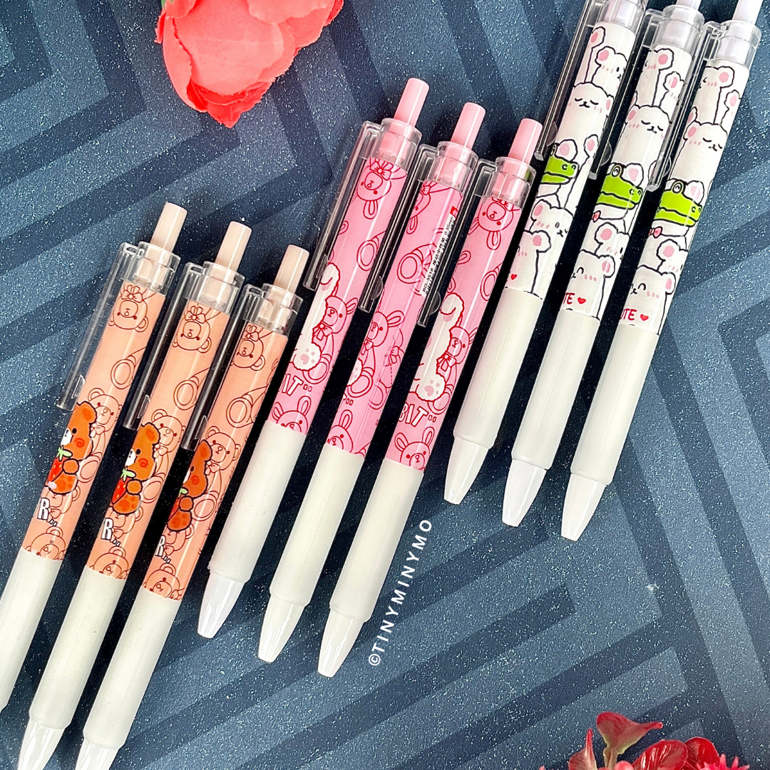 Three Sets of Kawaii Animal Gel Pens with Cartoon Designs Placed on a Patterned Surface – Tinyminymo