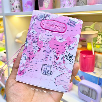 Pink Kawaii Passport Cover with 'World Trip' Text Held in a Hand - Tinyminymo
