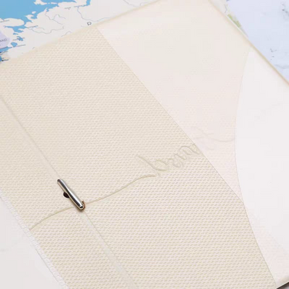 Close-Up of a Textured Inside of White Kawaii Passport Cover with World Map Design on a Light Blue Background - Tinyminymo