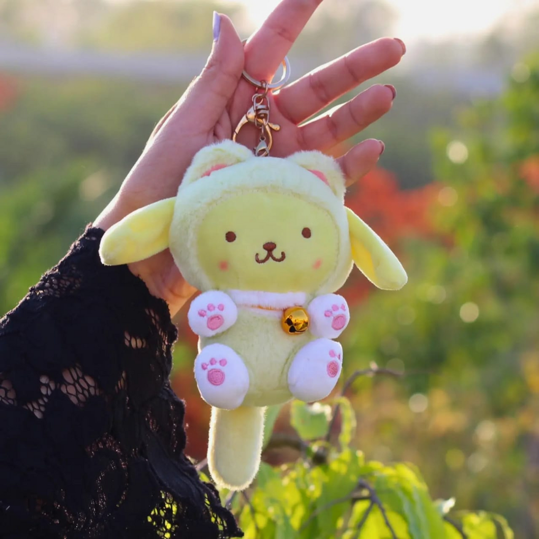 Pompompurin Variant of Kitty Cosplay Sanrio Plush Keychain is Held by a Hand - Tinyminymo
