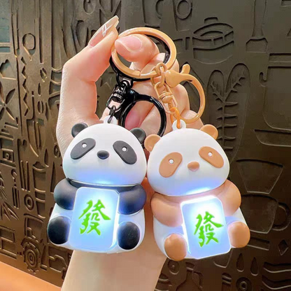 Two Lightup Panda Keychain with LED Light Box Held by a Hand - Tinyminymo