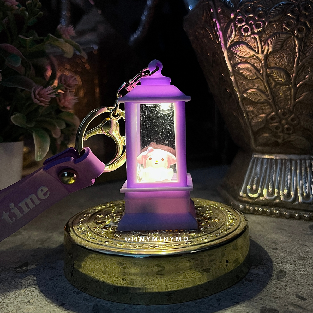 Purple Little Lightup Sanrio Keychain with My Melody Inside, Placed on a Dark Surface - Tinyminymo