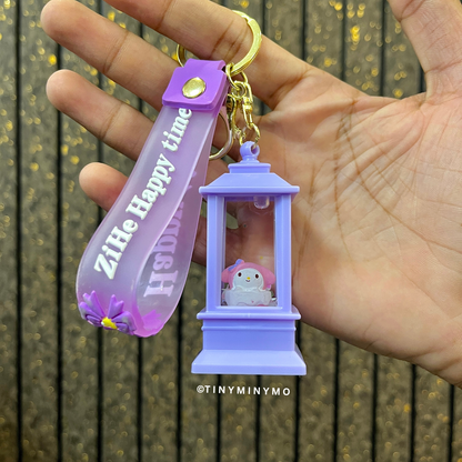 Lightup Sanrio Keychain with a Small My Melody Figure Held in a Hand Against a Wooden Background - Tinyminymo