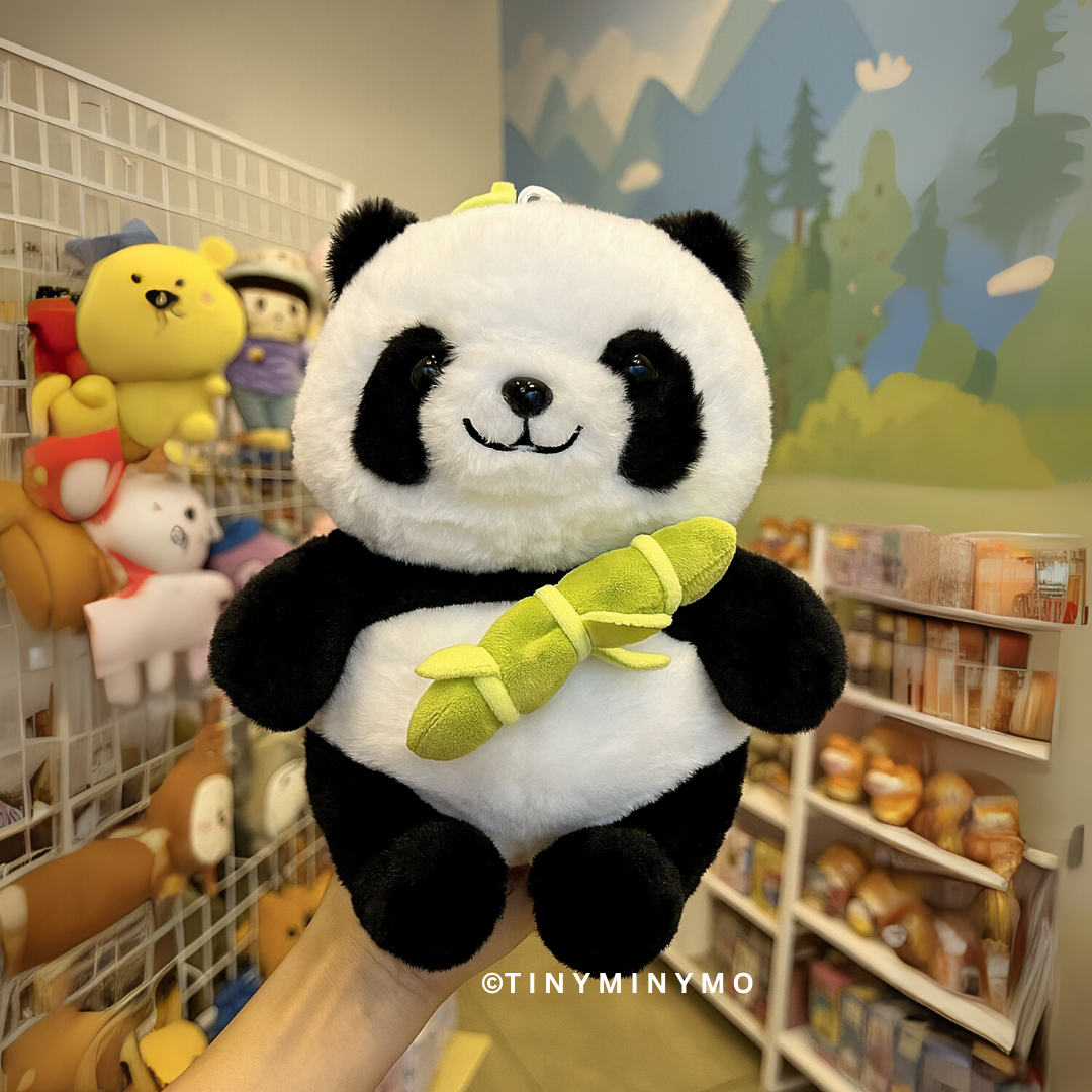 Little Panda Soft Toy Held in Front of Store Background - Tinyminymo