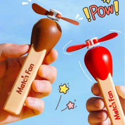 Two Match Stick Fans with Propellers, One Brown and one Red, Held by Hands Against Sky in Background with Cartoon Elements - TInyminymo