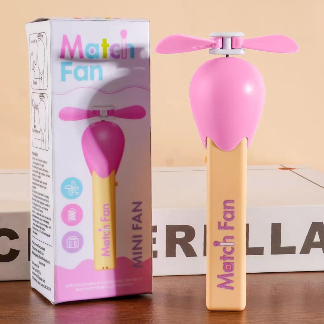 Pink Match Stick Hand Fan with Packaging on a Wooden Surface.- Tinyminymo