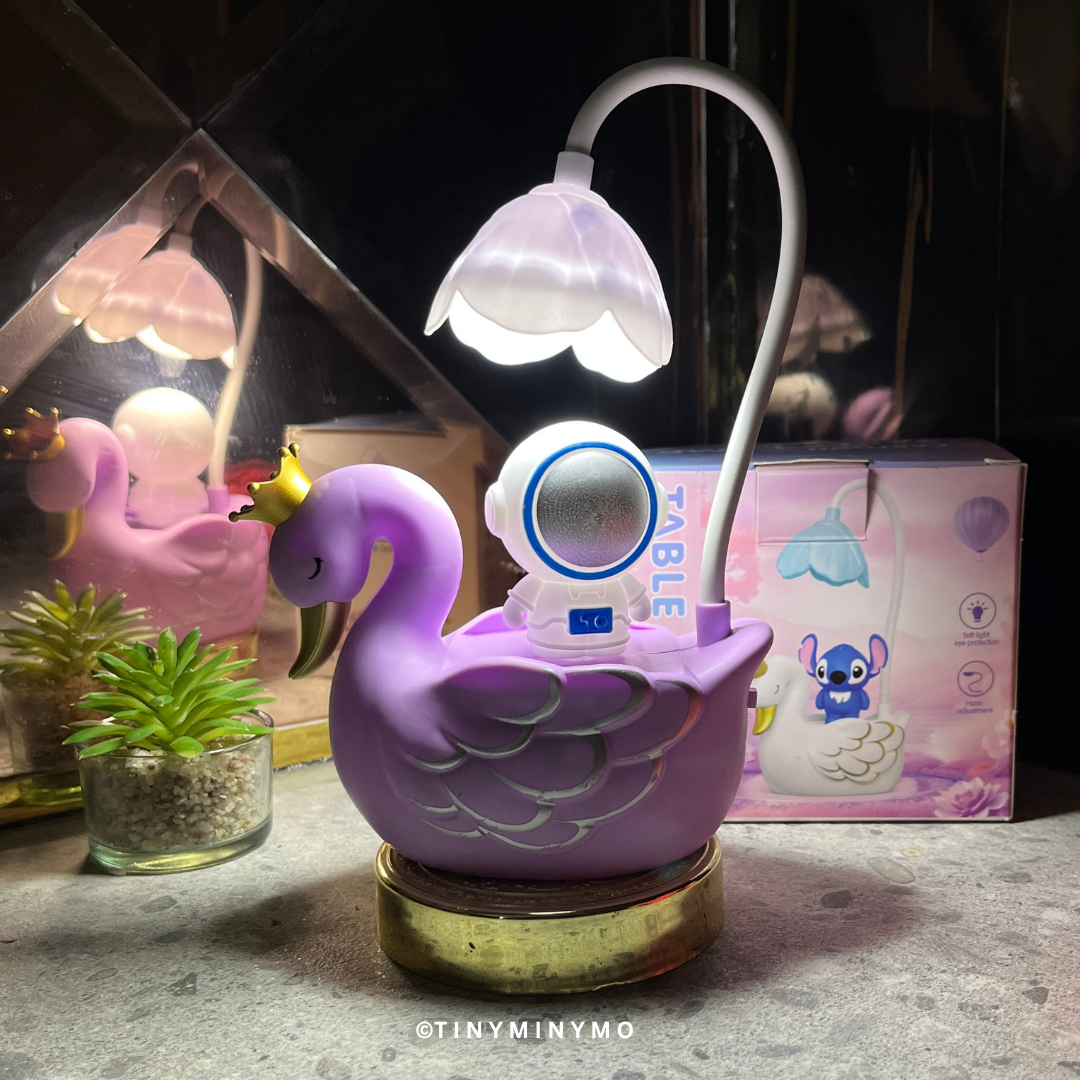 Purple Multifunctional Duck LED Desk Lamp with a Small Astranout Figure on a Textured Surface - Tinyminymo