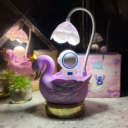 Purple Multifunctional Duck LED Desk Lamp with a Small Astranout Figure on a Textured Surface - Tinyminymo