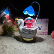 Multifunctional Duck LED Desk Lamp with a Small Pink Character on a Dark Surface - Tinyminymo
