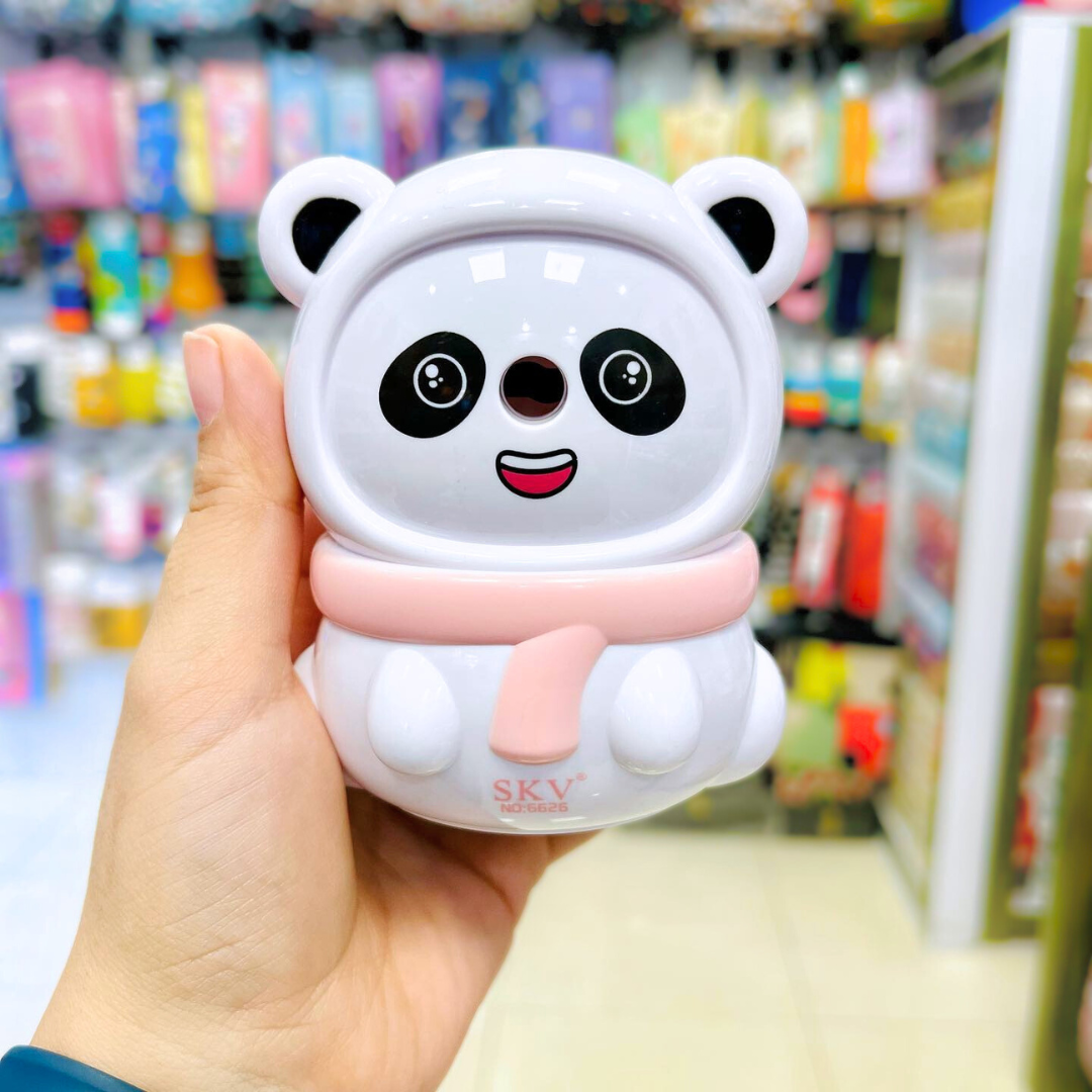 Panda Mechanical Sharpener held in a hand with a blurred store background - Tinyminymo