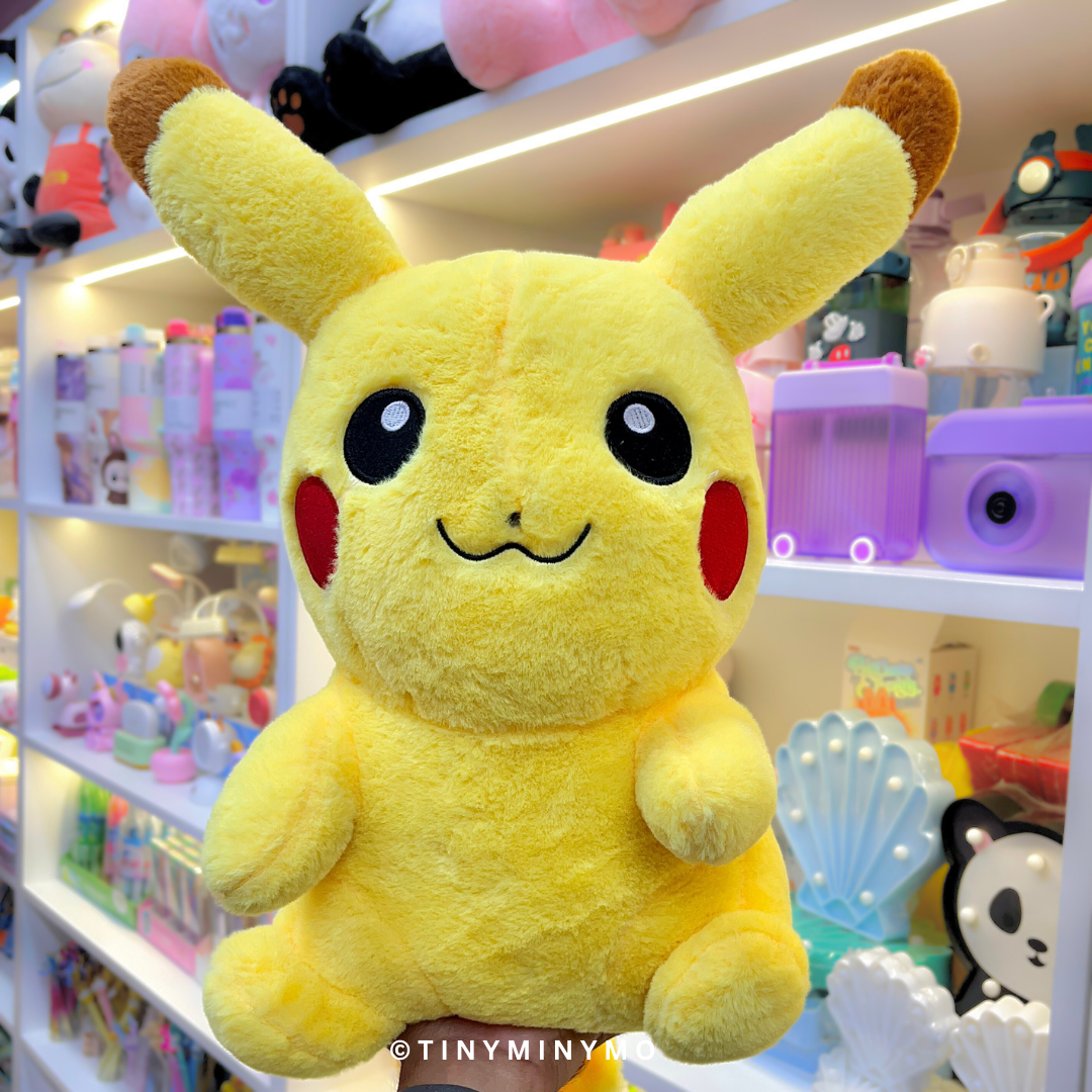 Pikachu Soft Toy in a store setting with various items on shelves - Tinyminymo