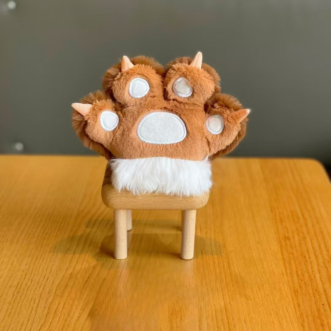 Brown Plush Paw 3D Keychain Placed on a Wooden Stool Over a Wooden Table, Set Against a Soft Gray Background - Tinyminymo