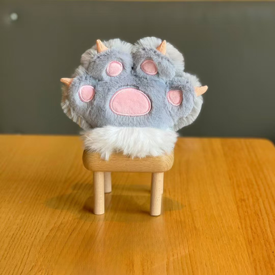 Grey Plush Paw 3D Keychain Displayed on a Small Wooden Stool Against a Neutral Background -Tinyminymo