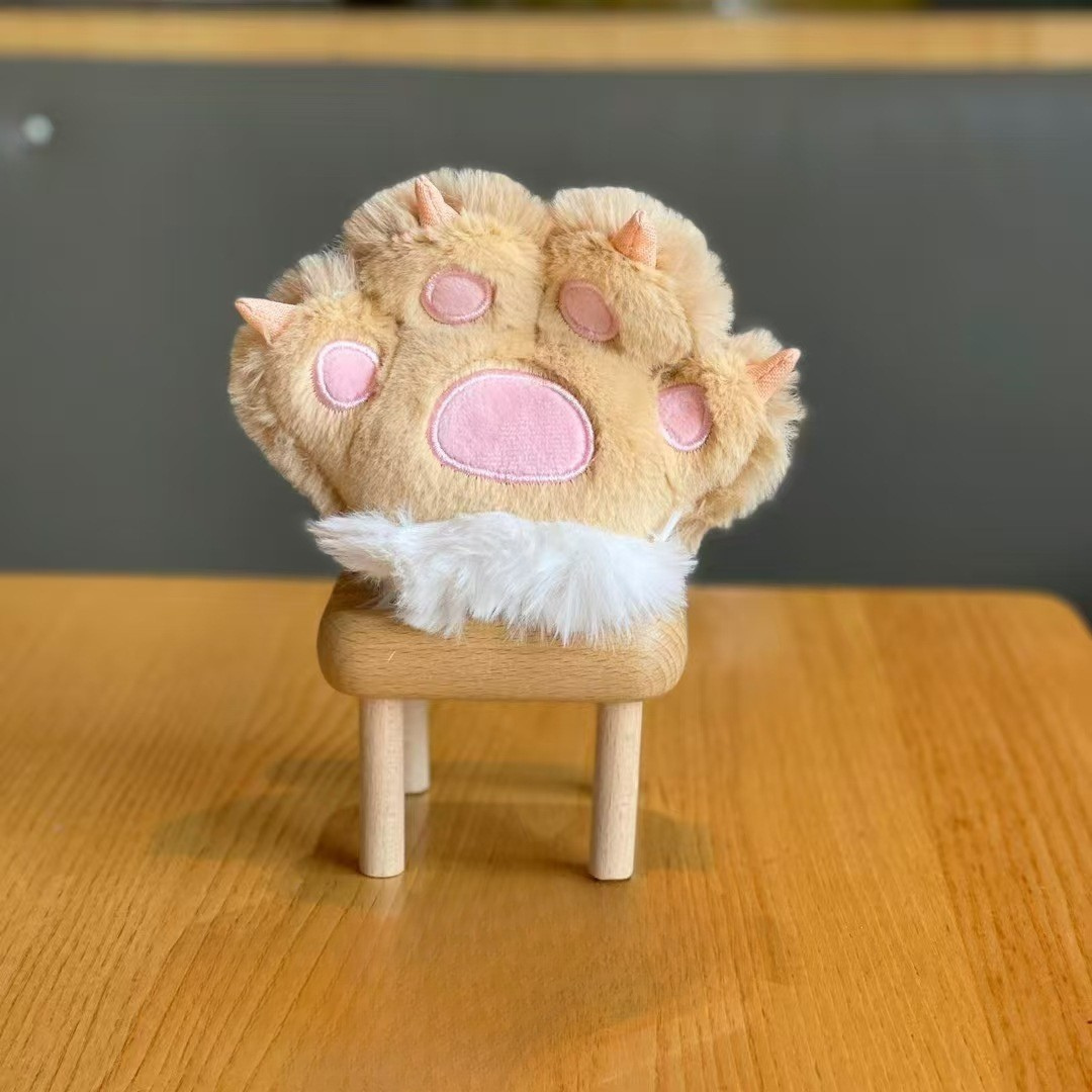 A Beige Plush Paw 3D Keychain Placed on a Wooden Stool Against a Neutral Background - Tinyminymo