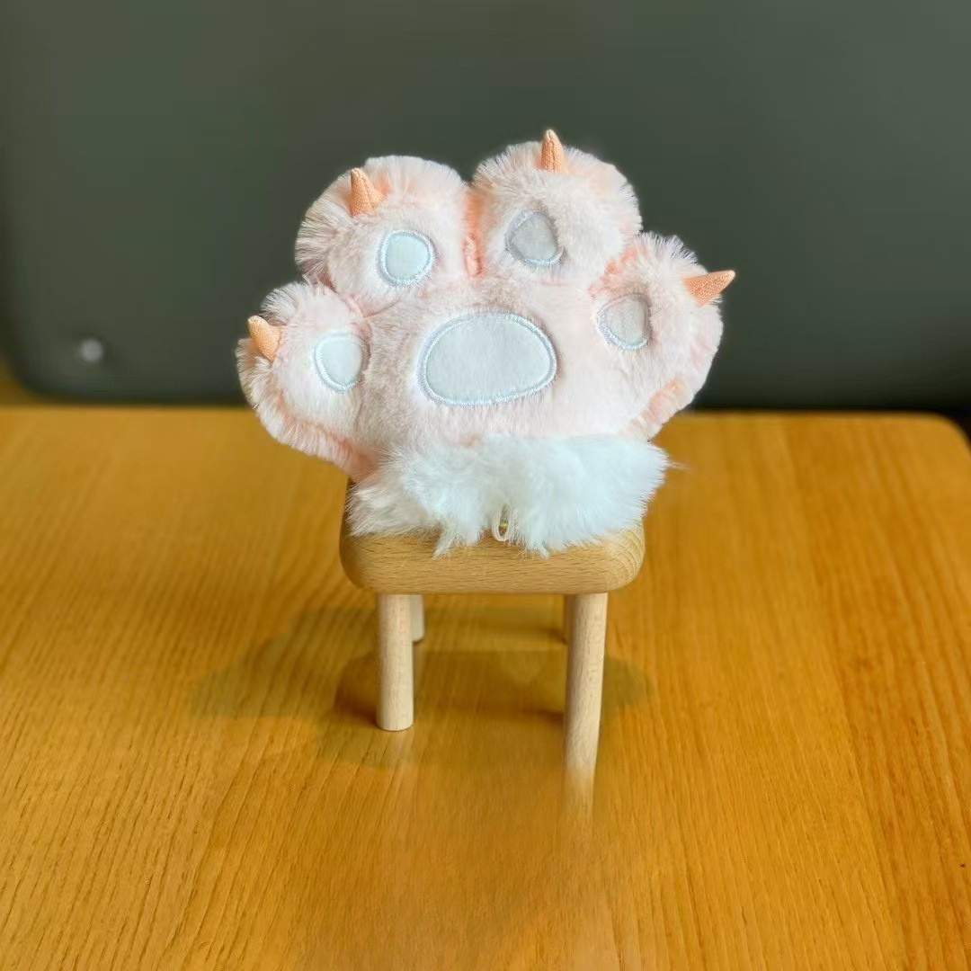 Peach Plush Paw 3D Keychain Shown on a Wooden Stool, Against a Dreamy Blurred Background - Tinyminymo