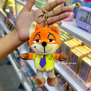 Plush Zootopia 3D Keychain Held by a Hand with a Blurred Store Background - Tinyminymo