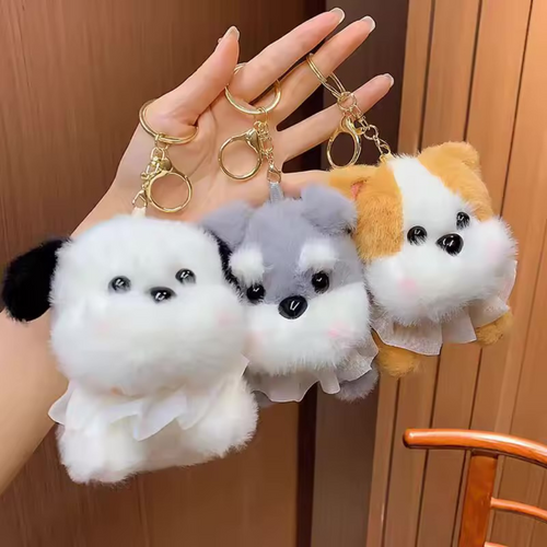 Three Pretty Puppy Plush Keychain held in a hand against a Wooden Background - Tinyminymo
