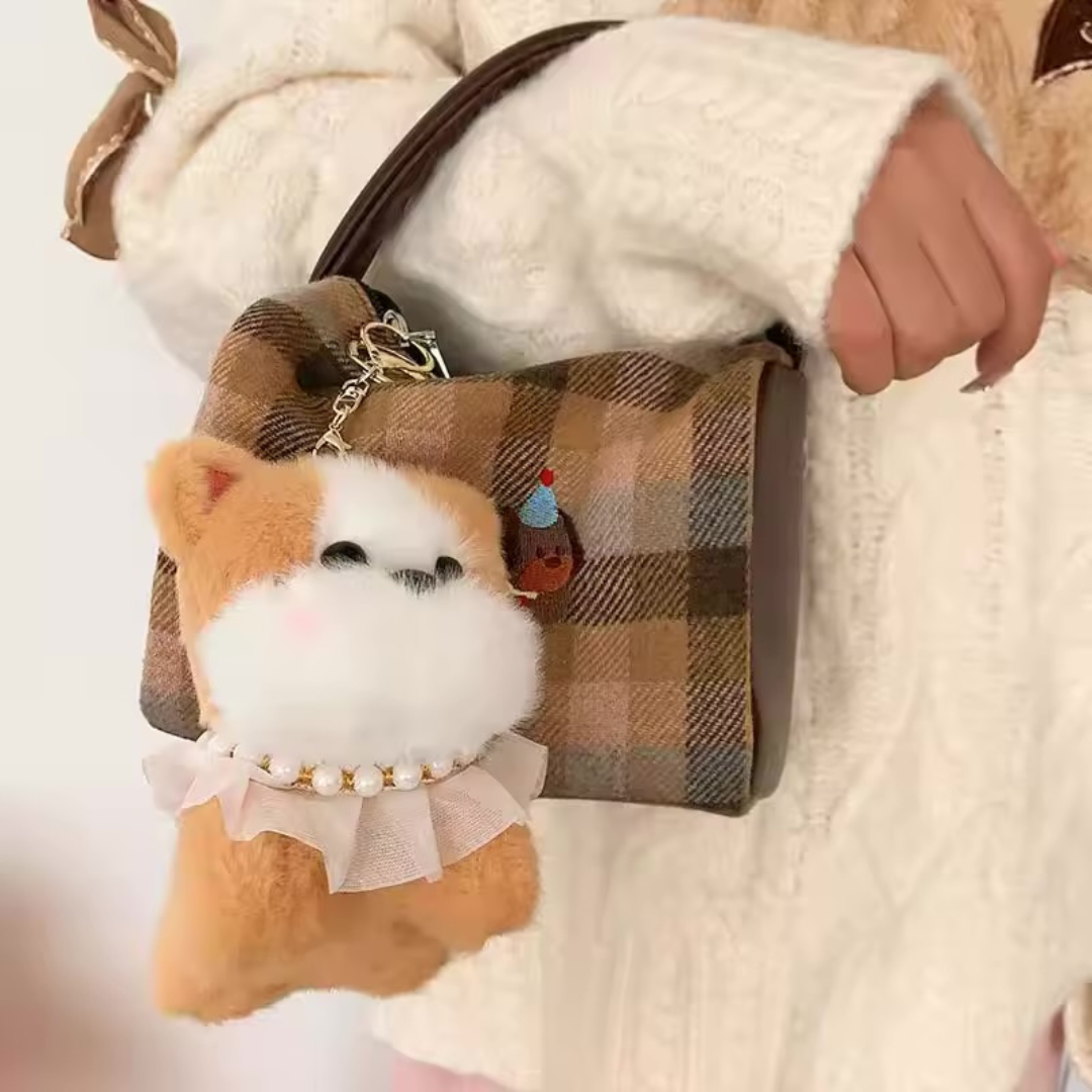 Plaid bag with a Pretty Puppy Plush Keychain attached, held by a person wearing a white coat - Tinyminymo
