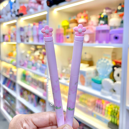 Two Pink Sakura Gel Pen held in hand front of a store shelf - Tinyminymo