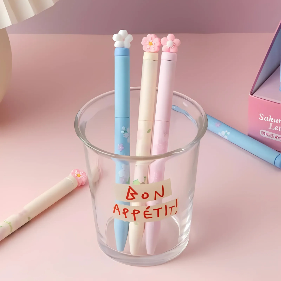 Three Sakura Gel Pen in a glass holder on a pink surface - Tinyminymo