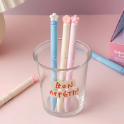 Three Sakura Gel Pen in a glass holder on a pink surface - Tinyminymo