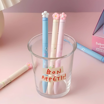 Three Sakura Gel Pen in a glass holder on a pink surface - Tinyminymo
