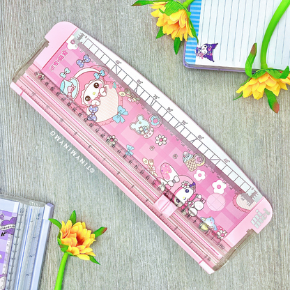Pink Sanrio Paper Trimmer with My Melody Print, Displayed on a Wooden Surface with Flowers and Stationery Items - Tinyminymo