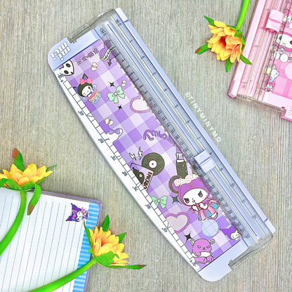 Sanrio Paper Trimmer on a Wooden Surface with Flowers and a Notebook - Tinyminymo