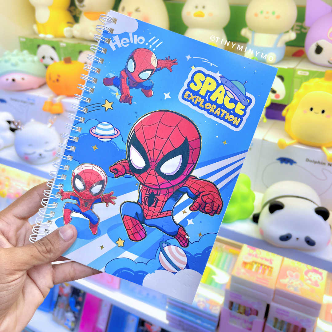 Spiderman Notebook held in front of colorful toys - Tinyminymo